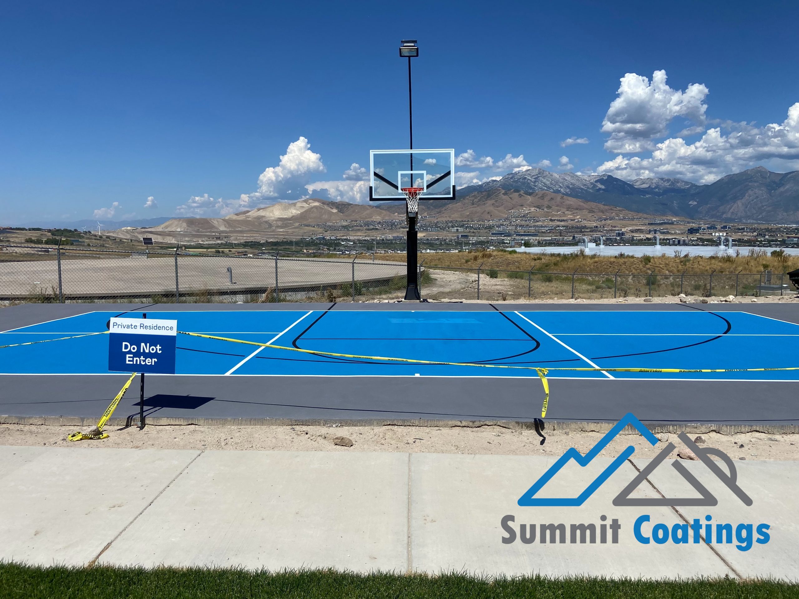Blue resurfaced pickleball and basketball court in northern Utah